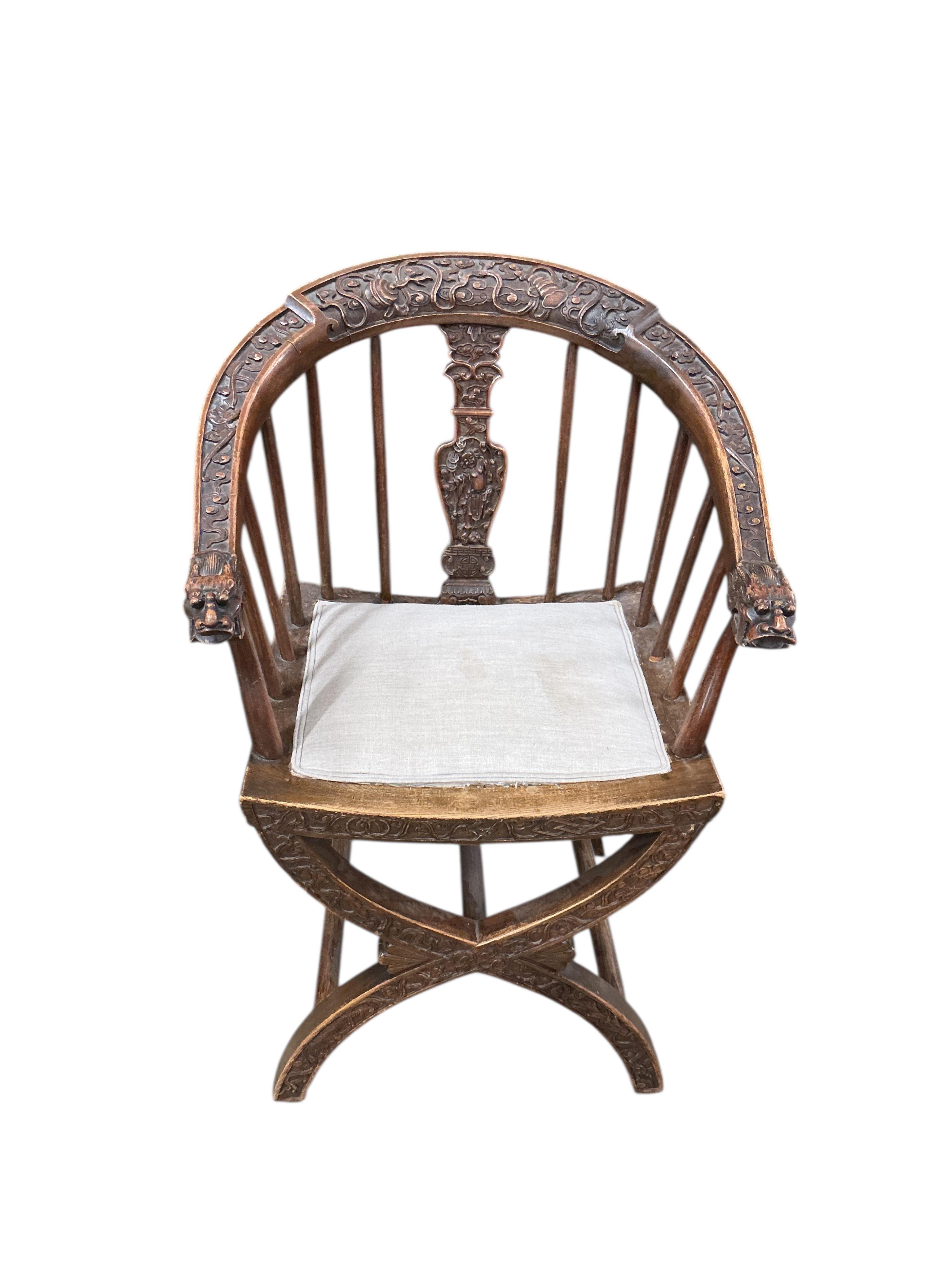 An Italian carved walnut 'X' frame elbow chair, width 58cm, depth 43cm, height 88cm